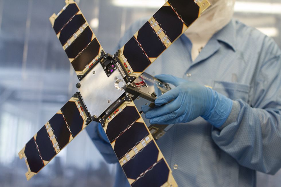 A scientist uses a small satellite in a laboratory